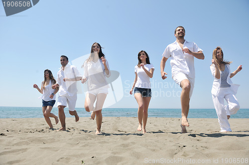 Image of happy people group have fun and running on beach