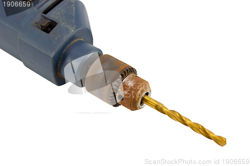 Image of Rusty old electric drill golden bit closeup 