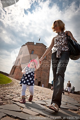 Image of Mother and baby walking in old city