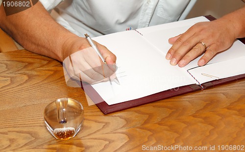 Image of witness signing marriage license or wedding contract 