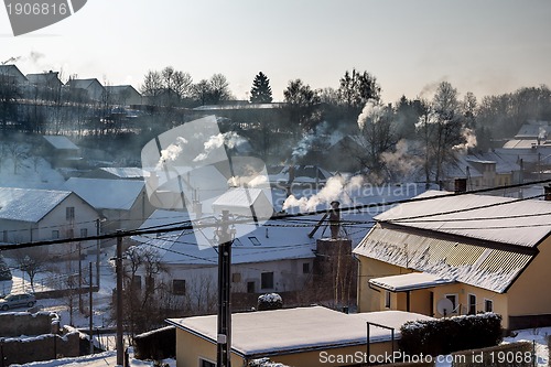 Image of non ecologic smoking chimneys in small village