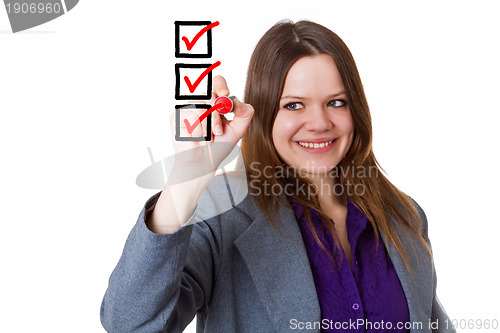 Image of Young woman writing a check mark