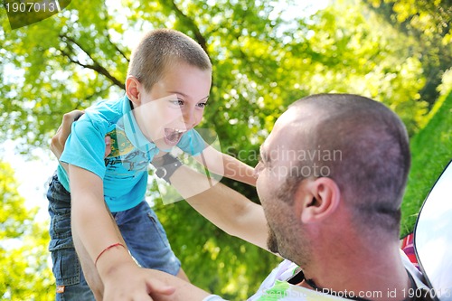 Image of happy father and son have fun at park