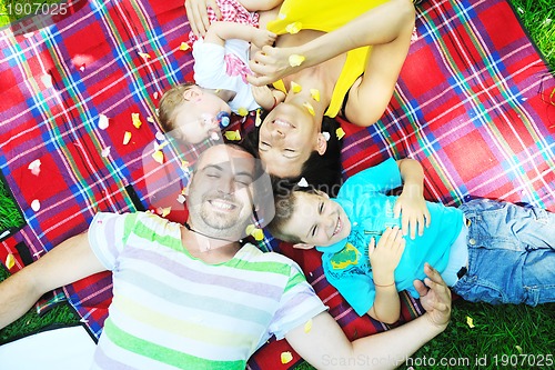 Image of happy young couple with their children have fun at park
