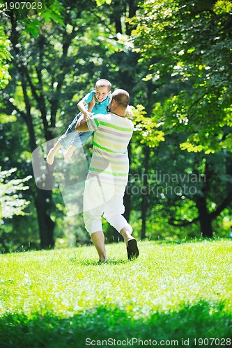 Image of happy father and son have fun at park