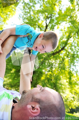 Image of happy father and son have fun at park