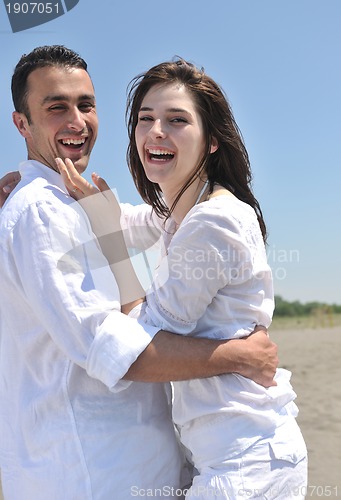 Image of happy young couple have fun on beach