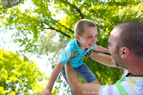 Image of happy father and son have fun at park