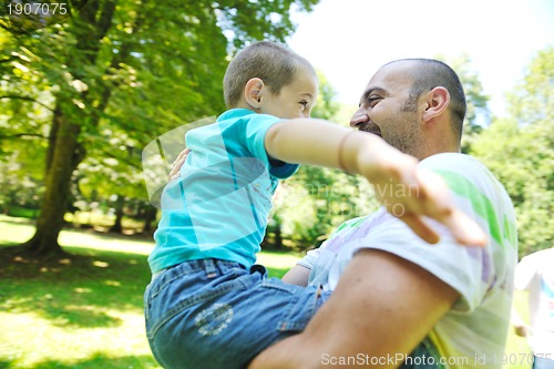 Image of happy father and son have fun at park