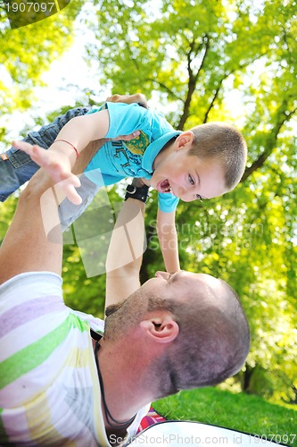 Image of happy father and son have fun at park