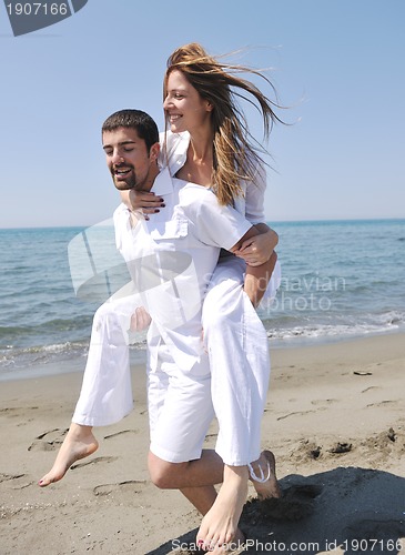 Image of happy young couple have fun on beach