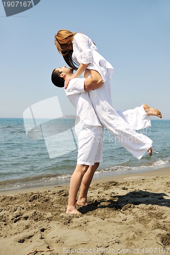 Image of happy young couple have fun on beach