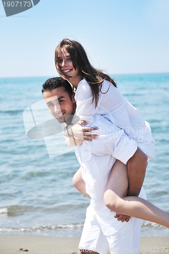 Image of happy young couple have fun on beach