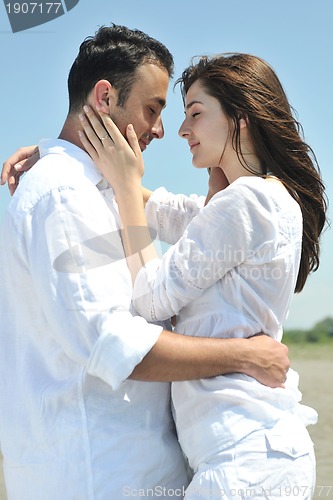 Image of happy young couple have fun on beach