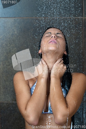 Image of sexy young woman enjoing bath under water shower