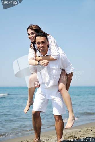 Image of happy young couple have fun on beach