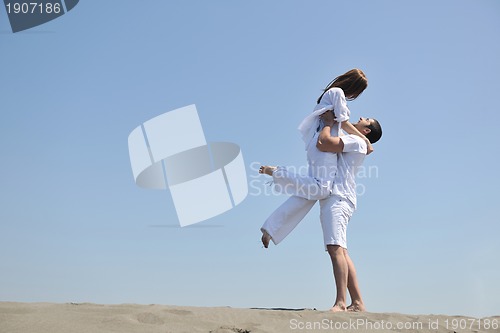 Image of happy young couple have fun on beach