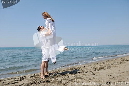 Image of happy young couple have fun on beach