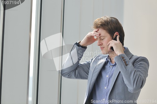 Image of young business man talk by cellphone