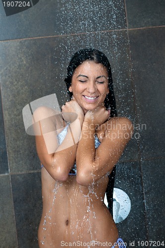 Image of sexy young woman enjoing bath under water shower