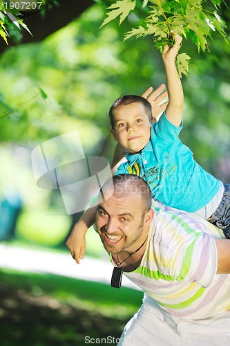 Image of happy father and son have fun at park