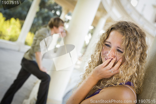 Image of Woman Upset While Man Comtemplates in the Background