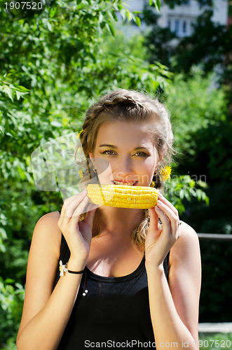 Image of woman eating corn-cob