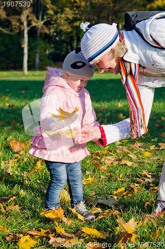 Image of grandmother with the grand daughter in autumn park