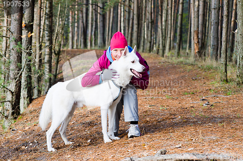 Image of The woman with a dog in a forest park
