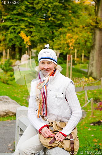 Image of a middle-aged woman in autumn Park