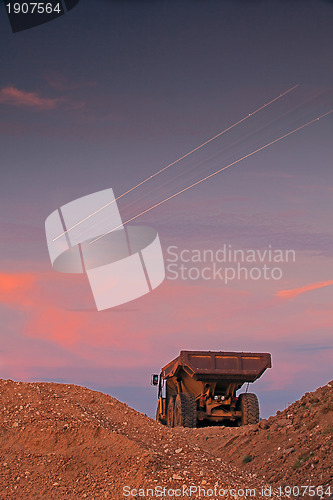 Image of Picture of a large truck and light lines from airplane