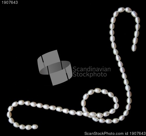 Image of White pearls on the black velvet background 