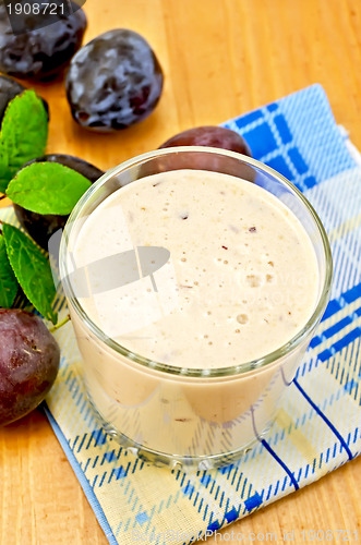Image of Milkshake with plums on a napkin