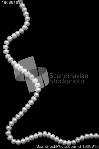 Image of White pearls on the black silk 