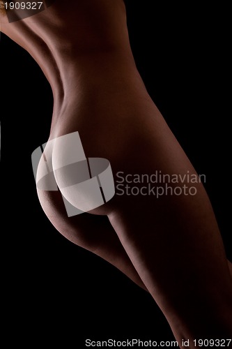 Image of Beautiful ass of young woman over dark background