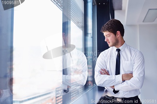 Image of happy young business man at office
