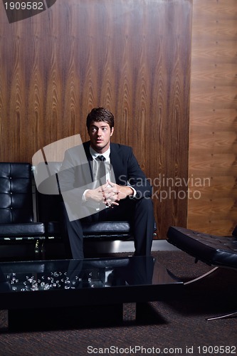 Image of happy young business man at office
