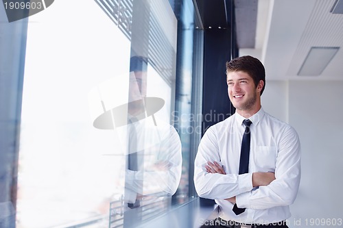 Image of happy young business man at office