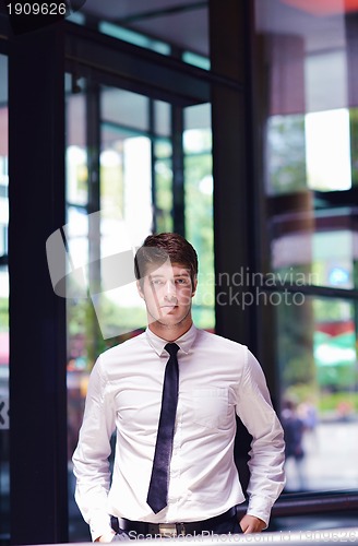 Image of happy young business man at office
