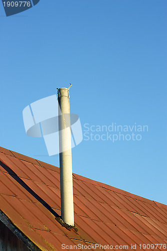 Image of Chimney on an old tinny roof