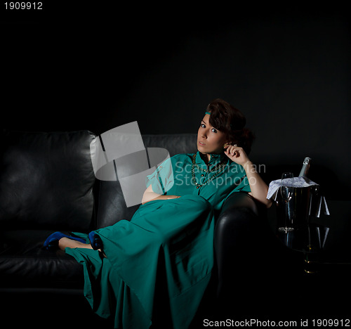 Image of Beautiful girl sitting on a sofa