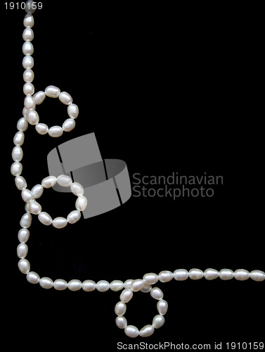 Image of White pearls on the black silk 