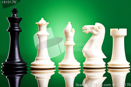Image of black king near white chess pieces