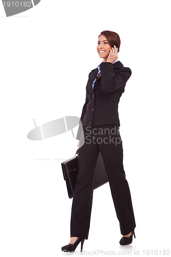 Image of walking business woman on the phone