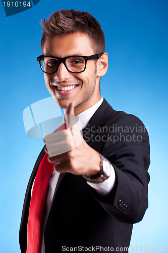 Image of Business man shows thumbs up ok gesture