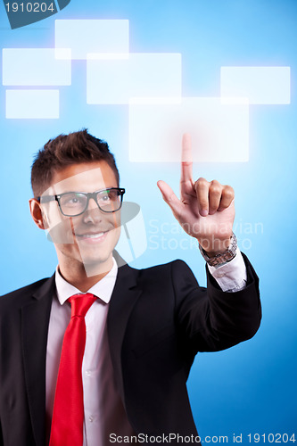 Image of business man pressing a touchscreen button 