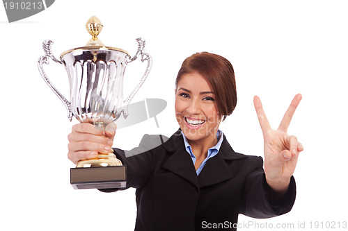 Image of business woman with trophy make victory gesture