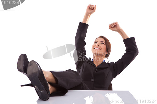 Image of relaxed and winning business woman sitting 