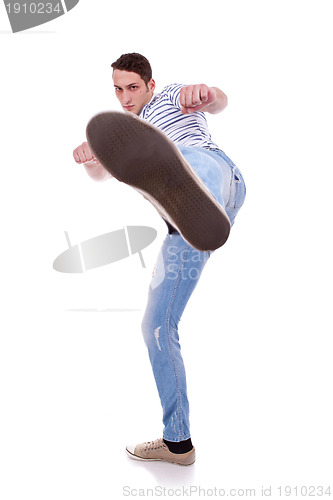 Image of young casual man kicking 