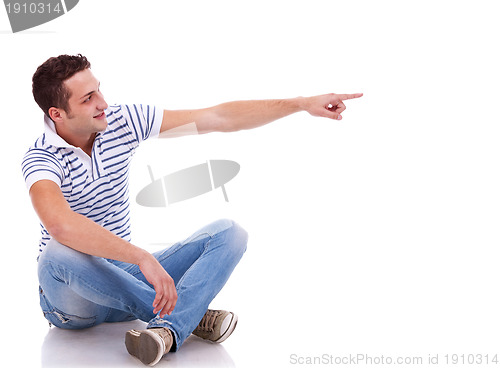 Image of young casual man pointing 